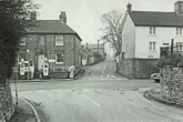 Falmer village towards the old main road showing Slark's garage on the corner and the road going towards the pond