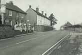Looking south Falmer village showing Slark's garage and a row of white faced cottages