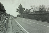 Looking North Falmer village showing Slark's garage in the distance and cottages on both sides of the A27