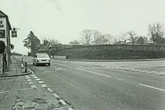 Looking north Falmer village showing the Swan Public House on the left and the bank and flint wall on the curve of the Falmer Road junction
