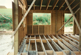 Wall partly boarded floor joists in place June 1998