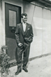 Brian in front of front door of prefab no. 47 where we lived