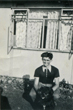 Bryan in front of prefab with dog 8/8/1953