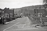 1954 Coldean Lane with two lodges on either side of road. Hikers Rest built 1927 in background.