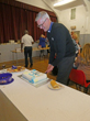 Fr William Leaf cutting the celebration cake